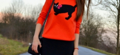 Orange sweater with black cat